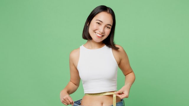 Young,Woman,Wear,White,Clothes,Show,Loose,Pants,After,Weightloss