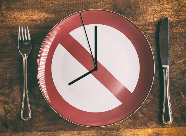 Skip breakfast concept with no symbol and clock on plate