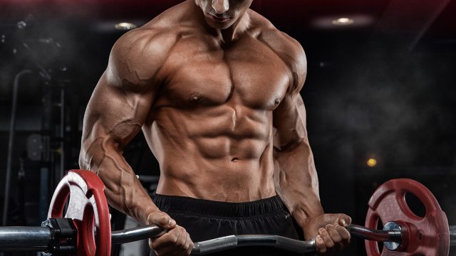 bald brutal sexy strong bodybuilder athletic fitness man pumping up abs muscles workout bodybuilding concept background