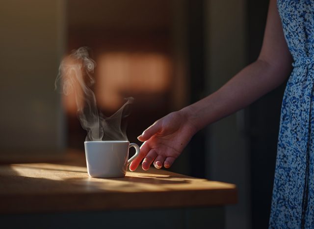 Woman is drinking coffee , morning routine. Tiny house. First property. Small apartment interior design. Minimalism. Moving in. Living alone. Charming trailer house with the morning sun
