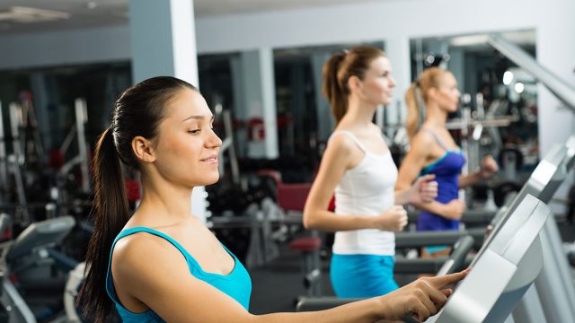 Young,Women,Running,On,A,Treadmill,,Exercise,At,The,Fitness