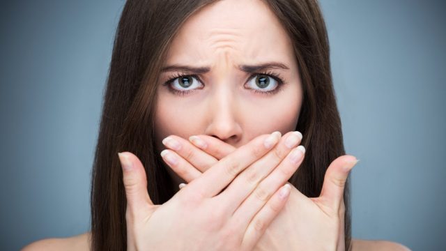 Woman covering mouth