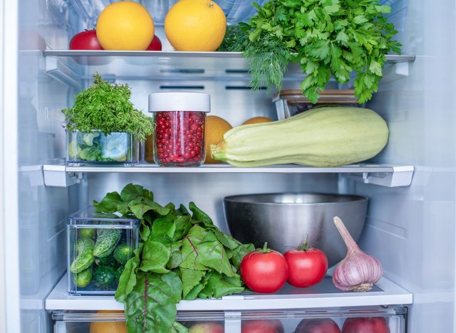 Open fridge full of fresh fruits and vegetables, vegetarian food healthy food background, greenery, organic nutrition, health care, dieting concept.
