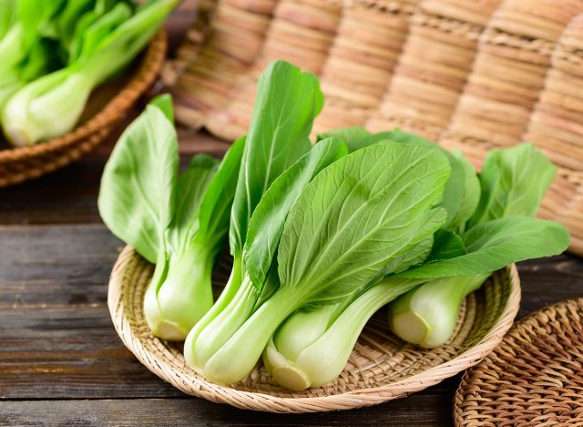 Fresh Bok Choy or Pak Choi(Chinese cabbage) in bamboo basket on wooden background, Organic vegetables