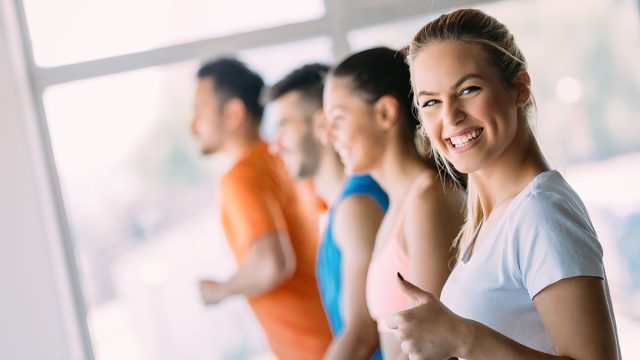 Young attractive woman doing cardio training in gym