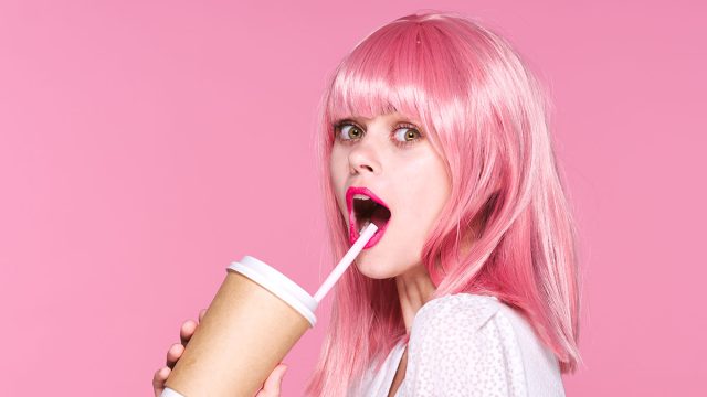 Beautiful woman with pink hair doll cup of coffee