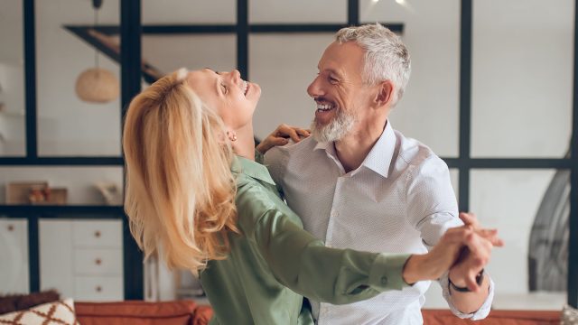 Dancing. Nice couple dancing in the room and looking happy