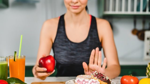 Young,Fit,Girl,Refuses,Eating,Doughnuts,And,Opts,For,Healthy