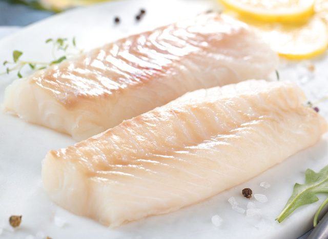 Fresh fish, raw cod fillets with addition of herbs and lemon
