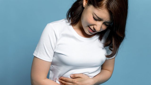 young woman having a stomachache