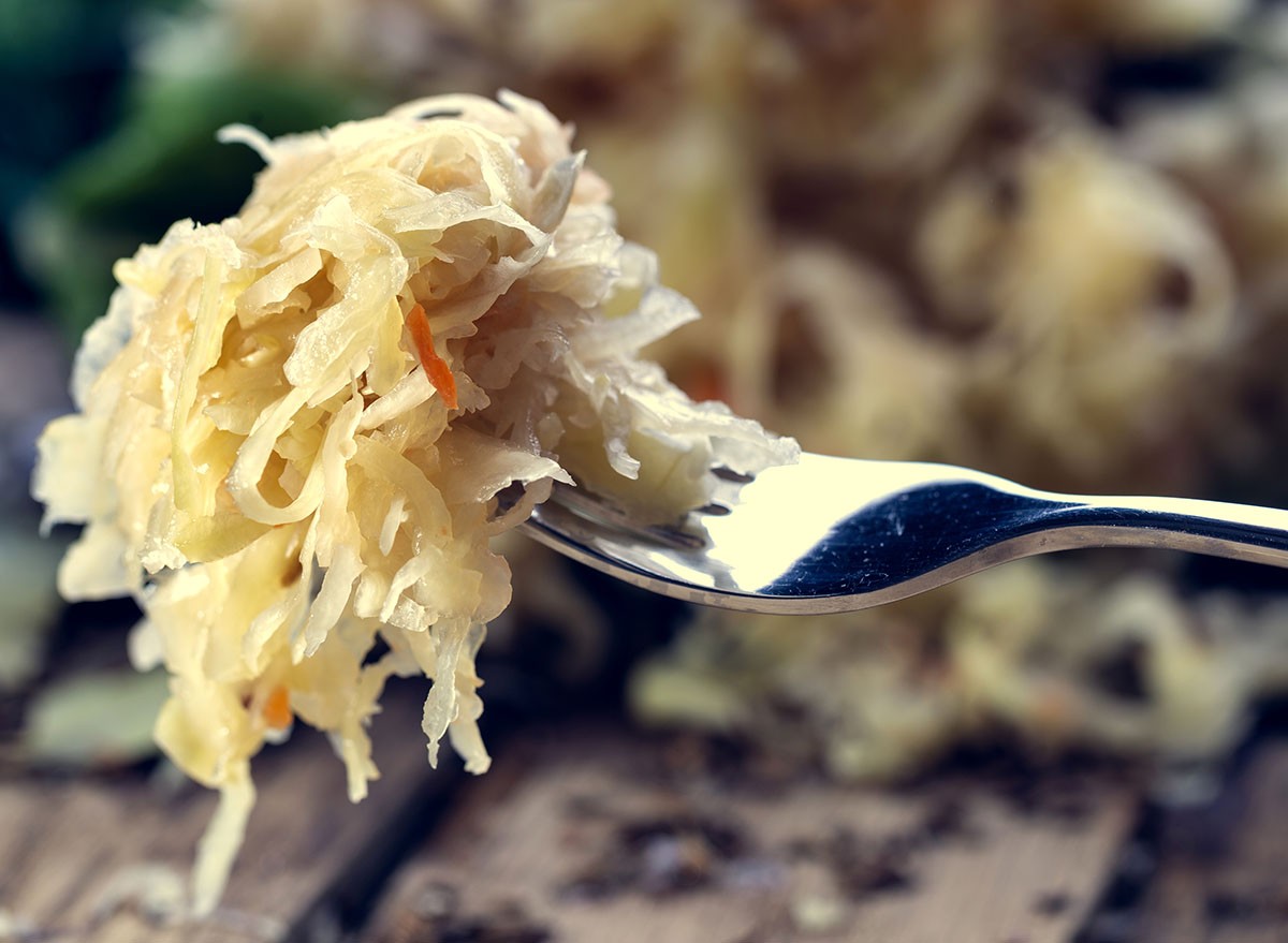 Sauerkraut on a fork with a shallow depth of field. Pickling cabbage at home. The best natural probiotic.