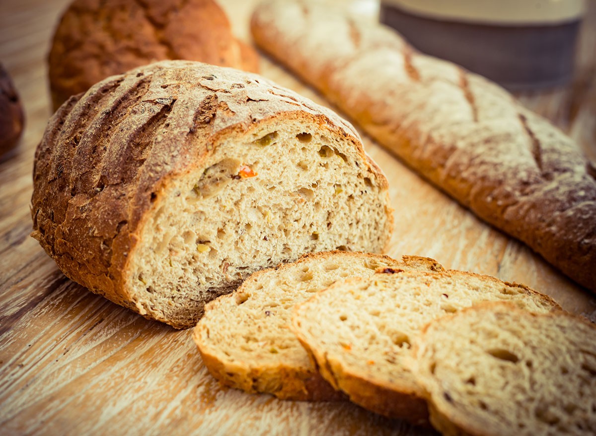 Freshly baked Ezekiel Bread / Bible Bread sliced, French Stick, Chilli, Cheese, Halloumi, Tomato. Bread bun.