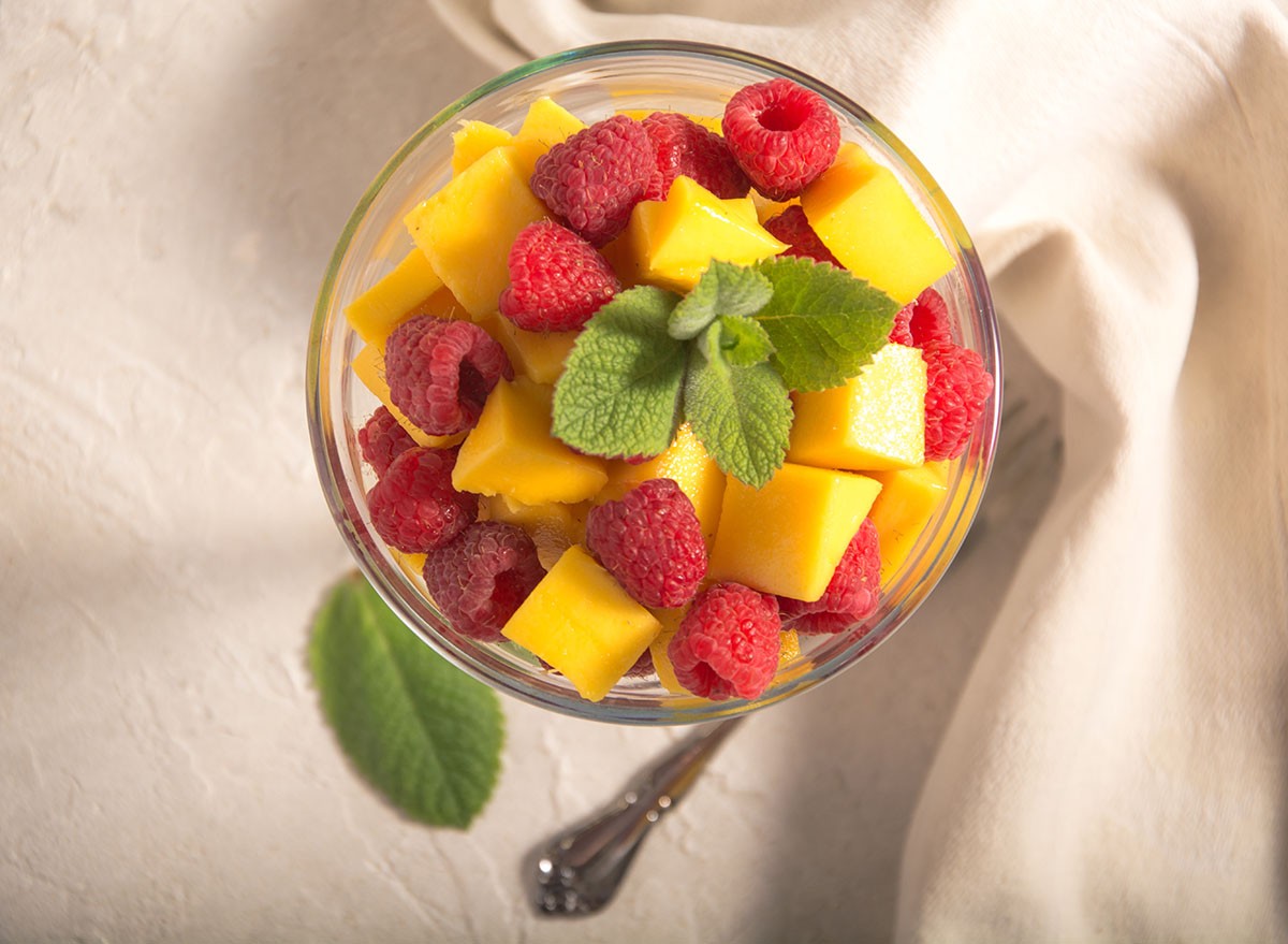 Delicious, fresh champagne mangoes and raspberries in a margarita glass, topped with a fresh mint sprig.  Wonderful breakfast food, or for any time the need for a healthy snack arises.