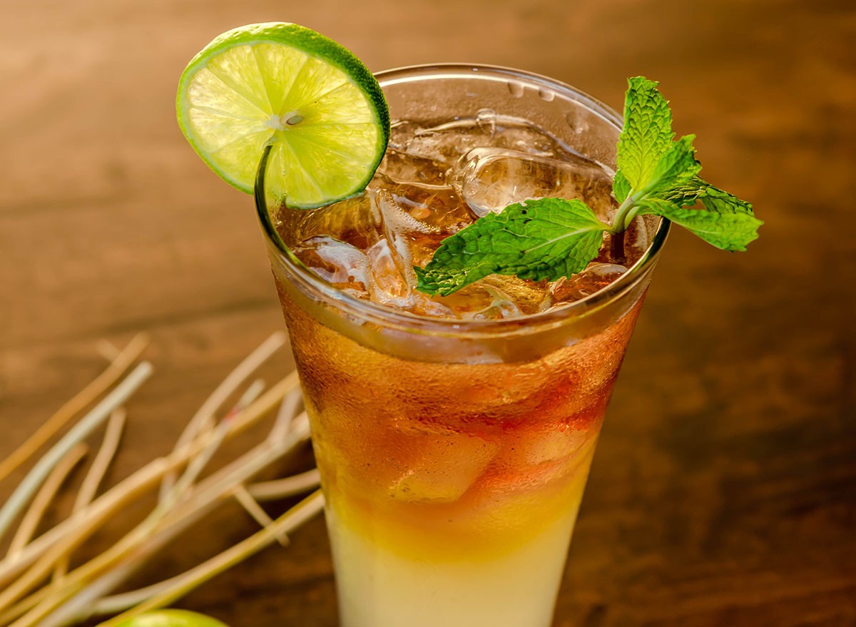 Cocktail Long Island Iced Tea on brown wood table