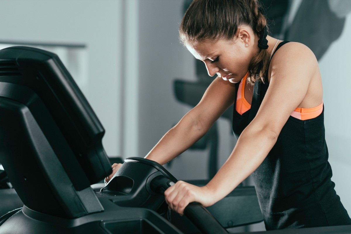 Treadmill exercising - woman exercising on treadmill, getting tired
