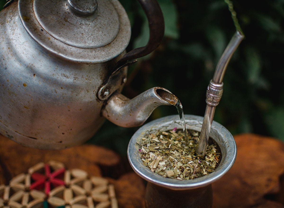 Brewing Yerba mate, steel kettle and traditional Argentine porongo mate, enjoying a good traditional Argentine mate in nature outdoors.