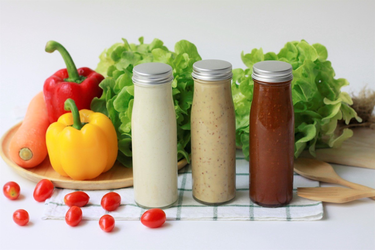Various,Glass,Bottles,Of,Salad,Dressing,With,Caesar,Dressing,And