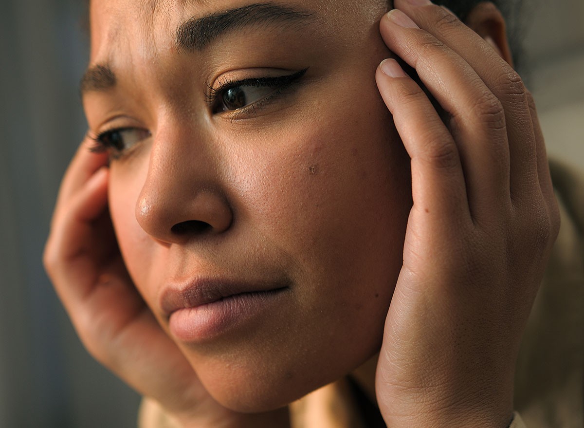 Close up unwell sad anxious African american woman sad face expression girl suffer headache health problem grief stressed frustrated female pain ache stress cry indoors upset worried hurt panic attack