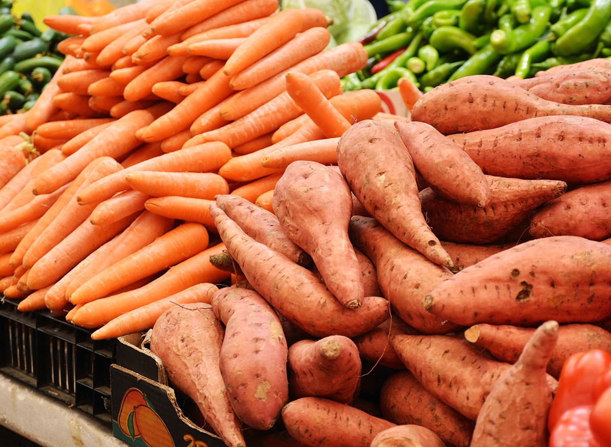 close up of sweet potato and carrot on market stand