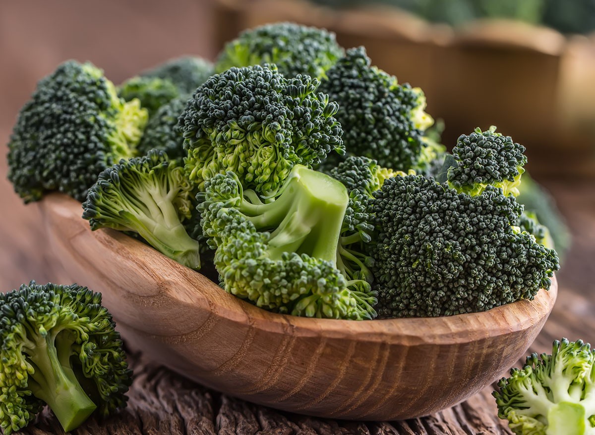 Raw fresh broccoli on old wooden table.