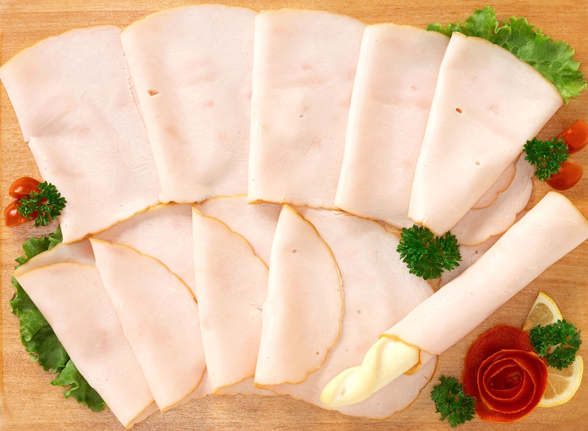 Slices turkey on wooden board