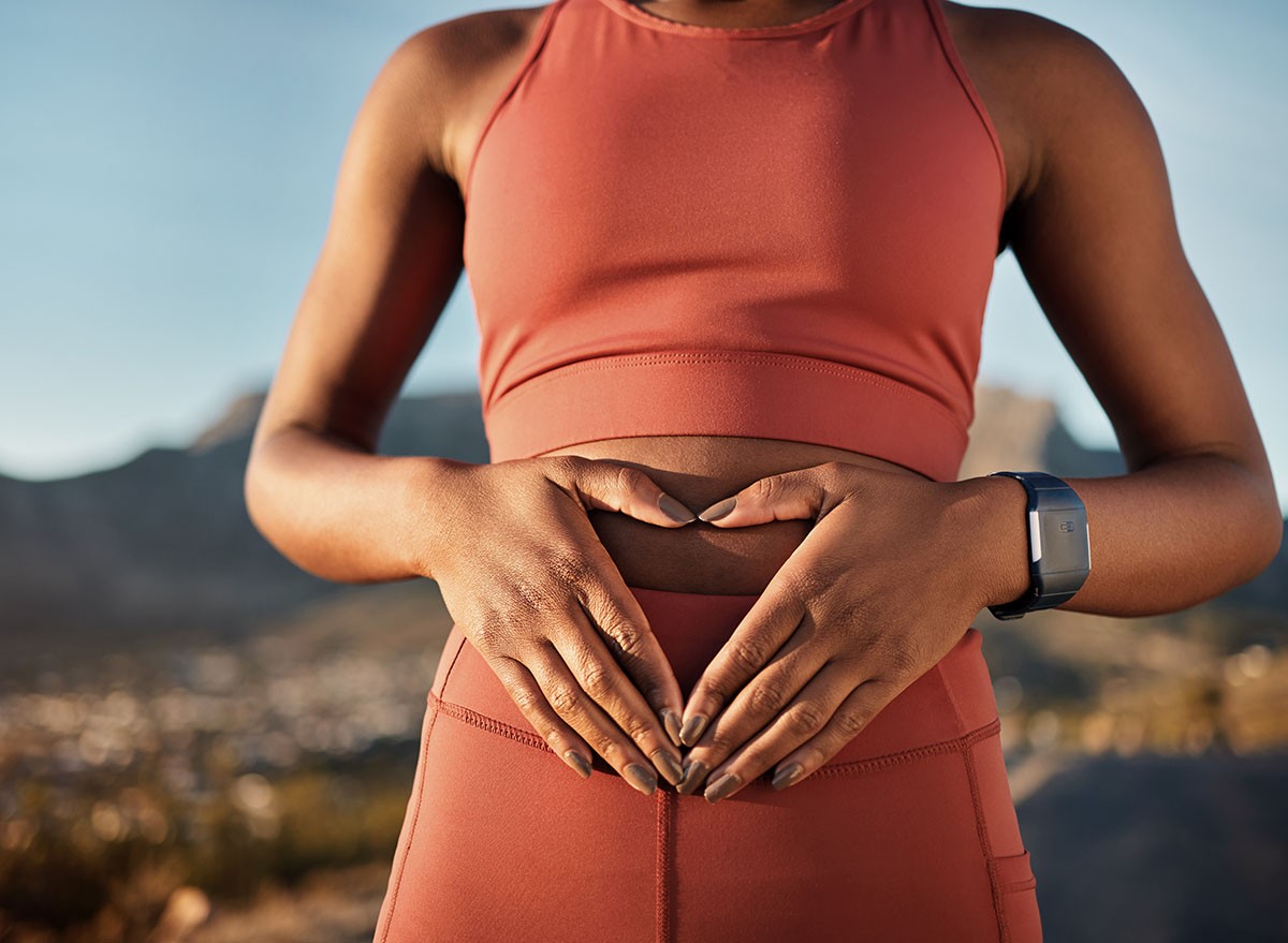 Woman, nature fitness or hands on stomach in diet wellness, body healthcare or abs muscle growth in workout training or sunrise exercise. Zoom, sports athlete or person, belly digestion or strong gut