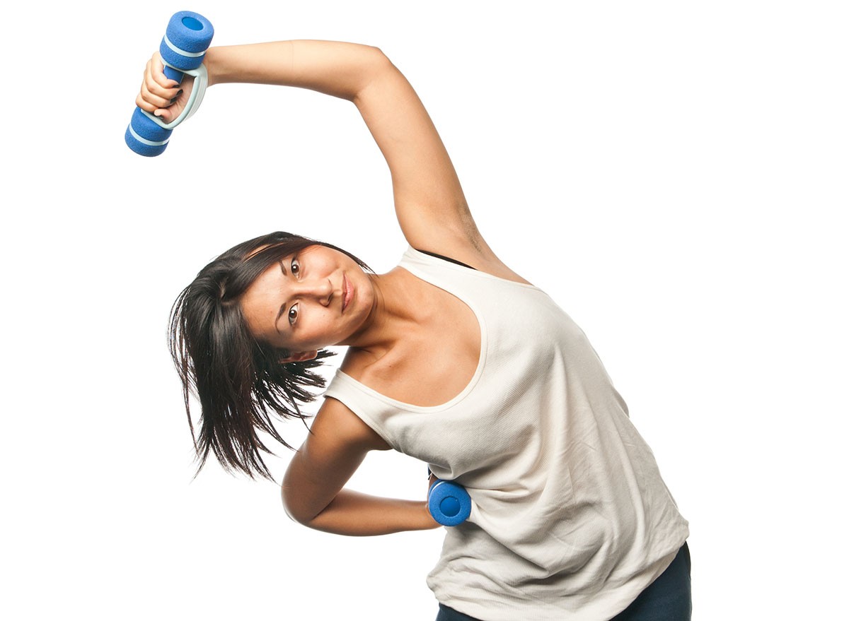 Sports girl doing exercises with dumbbells, Dumbbell Side Bends