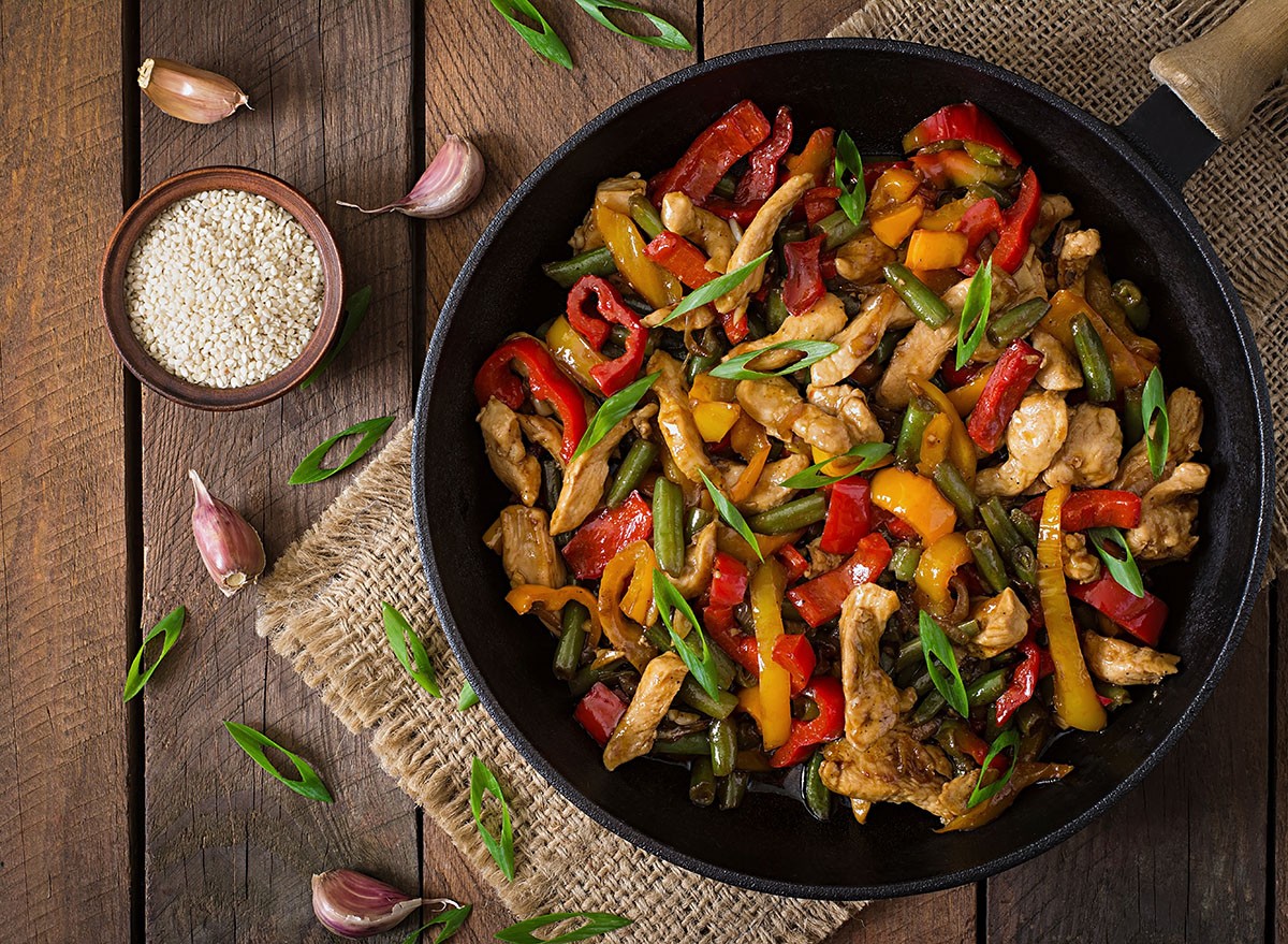 Stir fry chicken, sweet peppers and green beans. Top view
