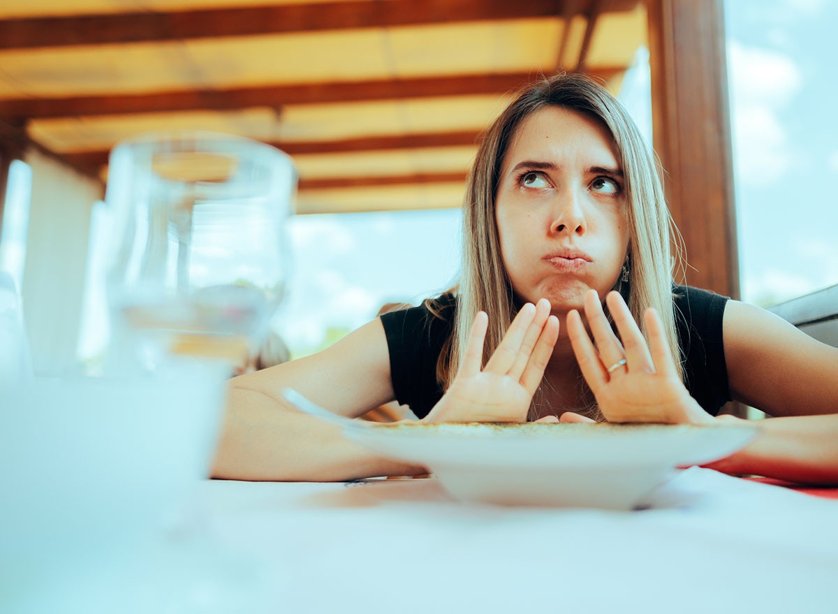 Woman Refusing to Eat her Meal Feeling Full. Customer sending the dish back unhappy with the serving