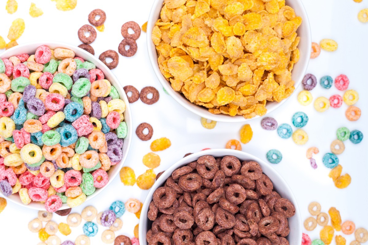 Three,Bowls,Of,Cereals,And,Cereals,Scattered,Around,The,Table