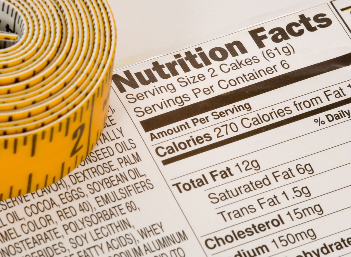 Yellow tape measure next to nutrition information on packaging in the USA, calorie, calories, label