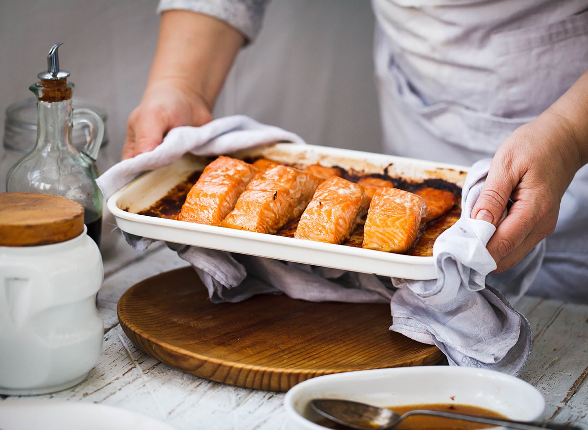 Salmon baked. Salmon fish hot fillets in baking tray. Salmon fillets with lemon and seasoning cooked in a baking pan.