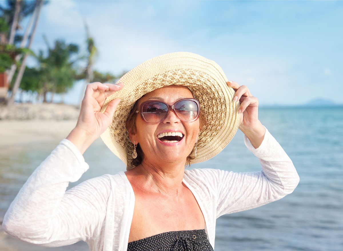 Happy mature woman of 50 years on the beach