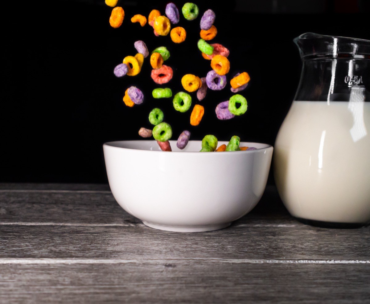 Colorful,Sugary,Cereals,Falling,Into,A,White,Bowl,And,Milk