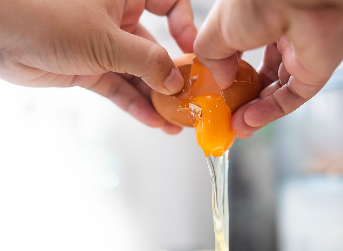 Egg concept.Woman hands broken egg flows into a bowl for making egg menu.chicken eggs for good health high protein the best for Ketogenic diet program.