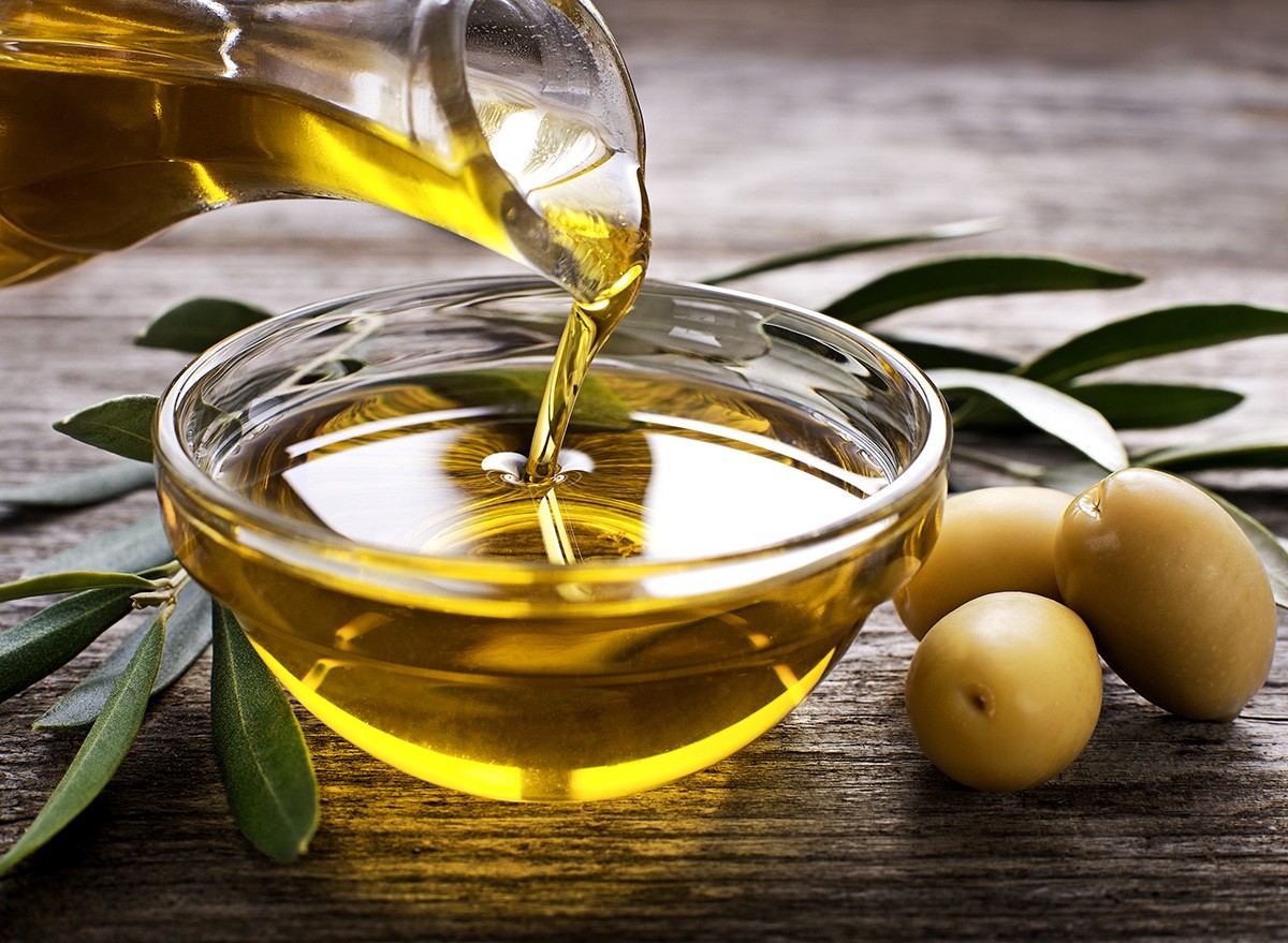 Bottle,Pouring,Virgin,Olive,Oil,In,A,Bowl,olives