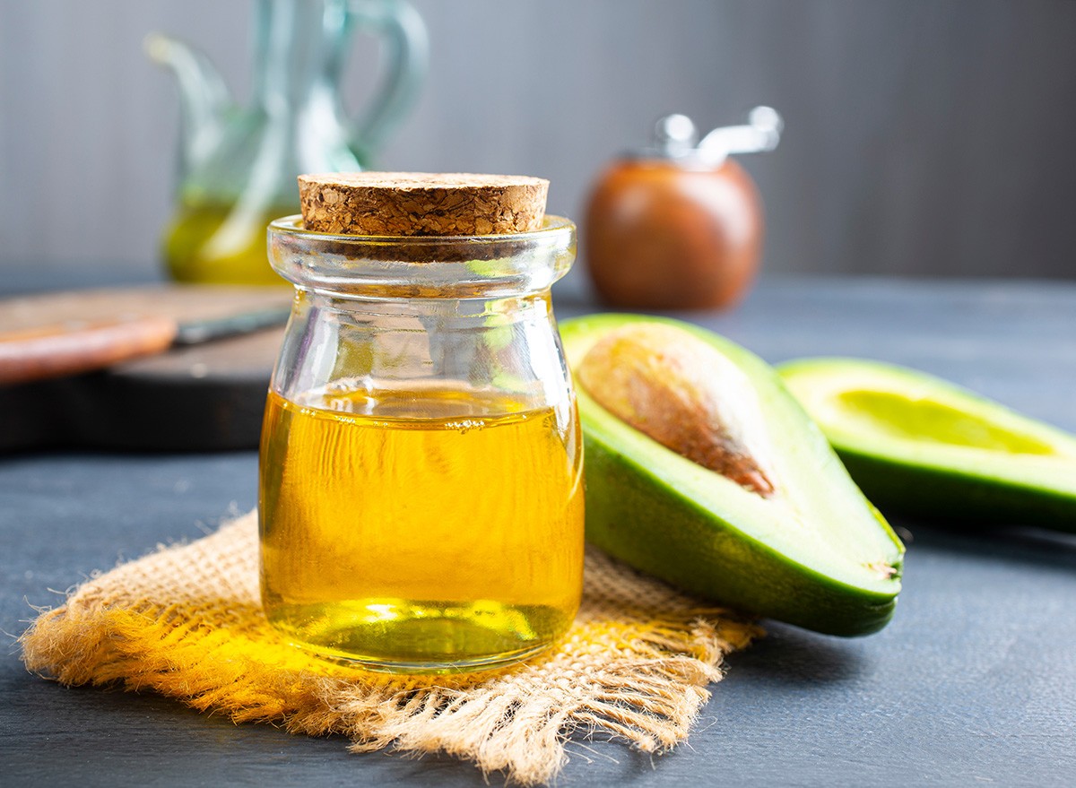 fresh avokado, green avocado and oil in bottle