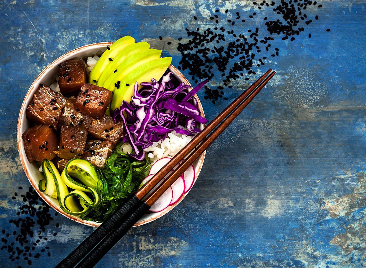 Hawaiian tuna poke bowl with seaweed, avocado, red cabbage, radishes and black sesame seeds