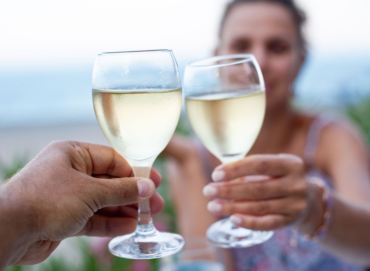 Toast for two to the sea during dinner. Alcohol, white wine,