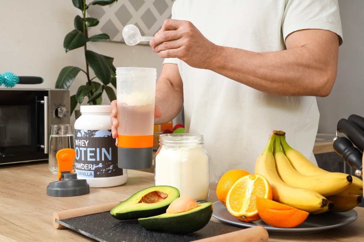 Sporty,Muscular,Man,Pouring,Protein,Powder,Into,Bottle,For,Shake